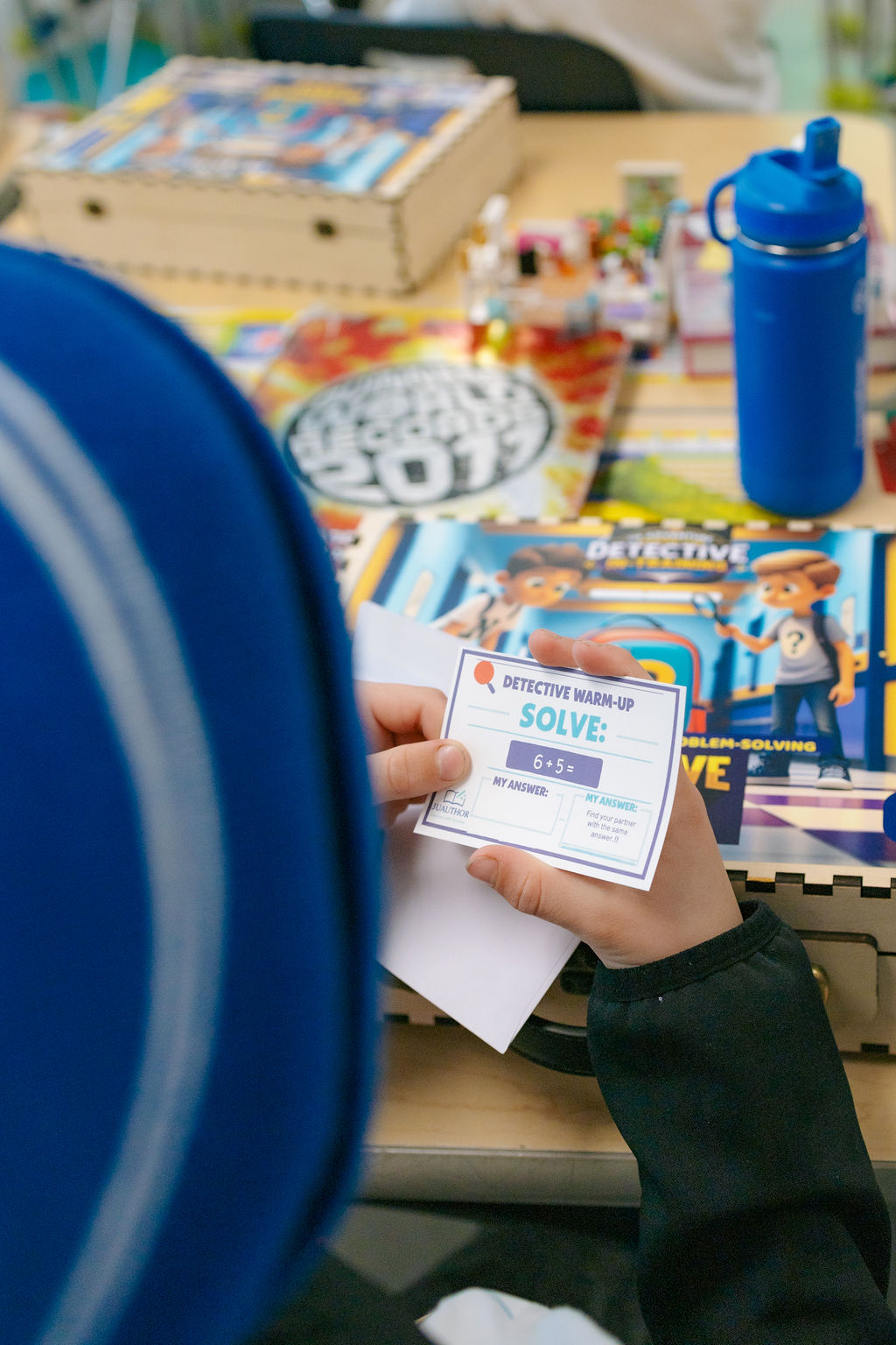 Detective warm-up game card with a math challenge